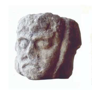 Angus of Mor? Carved head from the portal to the hall. © David Caldwell