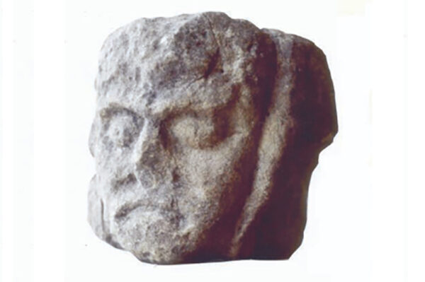 Angus of Mor? Carved head from the portal to the hall. © David Caldwell