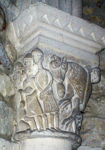 The bailiff, his son and kinsman? Capial from the eldest church preserved in the present church at de Lège. Source: Wikipedia/Didiee-ctp