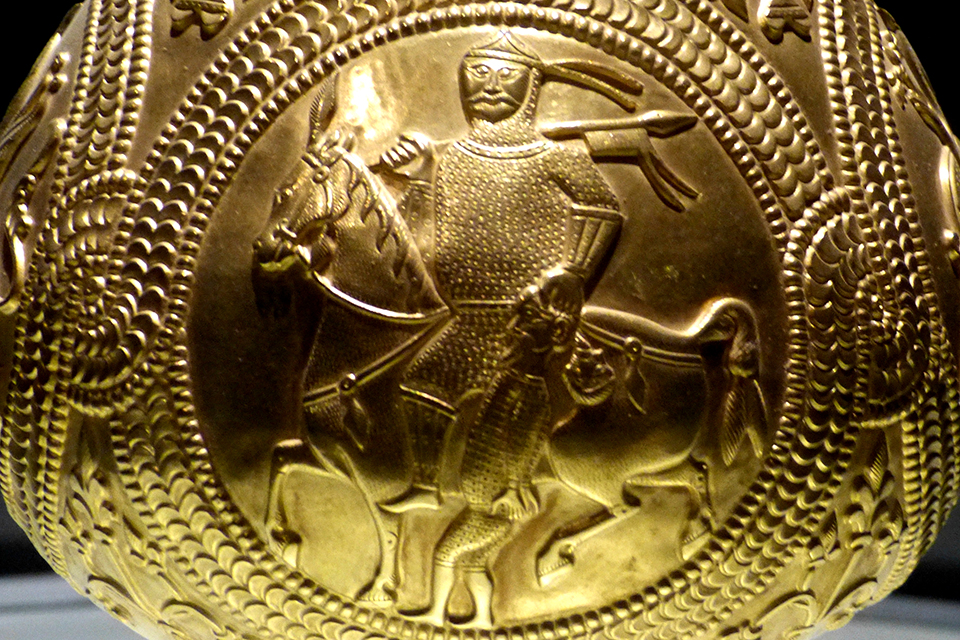 Avar Jug with medallions showing an Avar Warrior holding a captured prisoner of War. From the treasure of Nagyszentmiklos. Source. WIkipedia/Sauber CCBYSA40