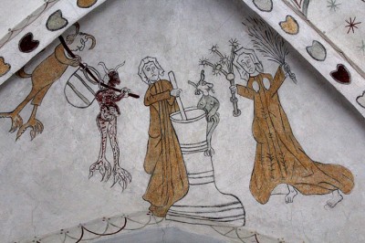 Woman working the churn with devil. Vejlby Church, Randers Denmark. Source: Pinterest
