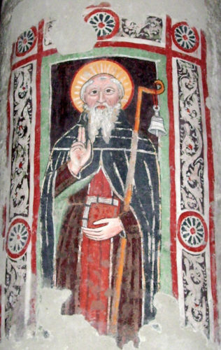 Columbanus with his symbols: Staff, hand-bell and book of Gospels Fresco of Saint Columbanus in Brugnato Cathedral. Source: Wikipedia/Davide Papalini