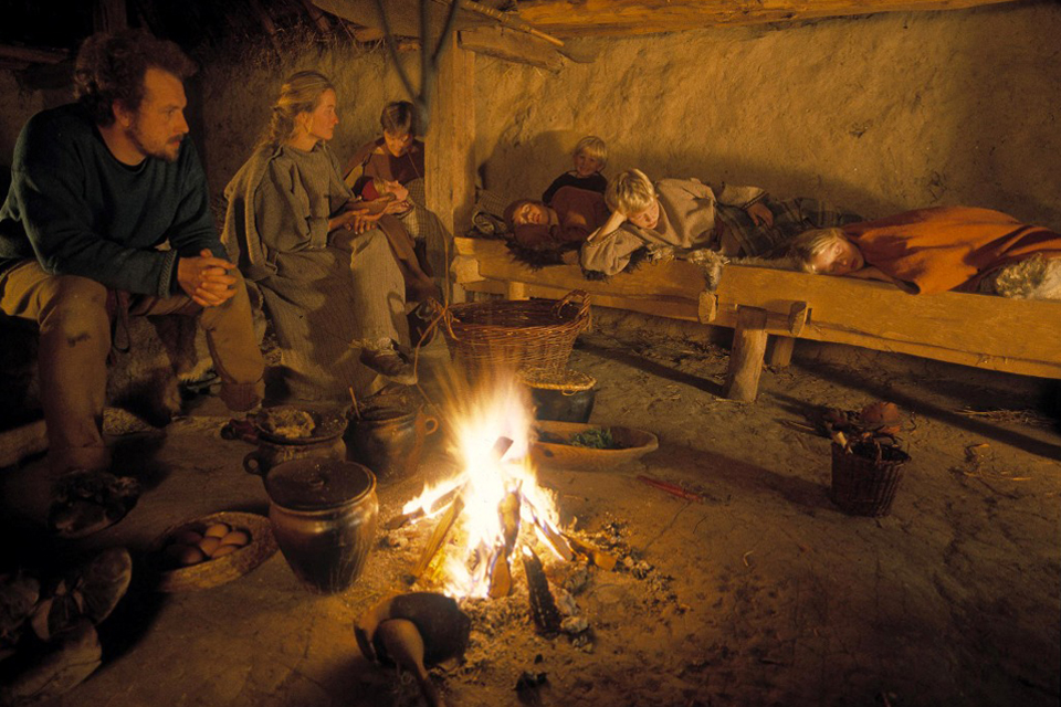 Huddling aorund the fire in an Iron Age house at Lejre