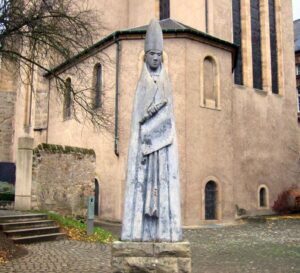 Willibrord in front of his church in Echternach