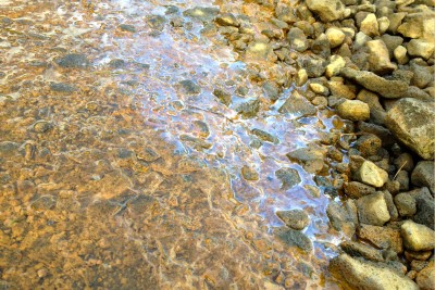 Film on stream indicating bog iron - Iceland